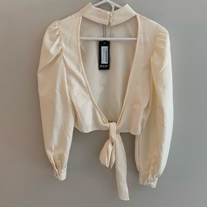 Nasty gal cream cropped blouse with open back.